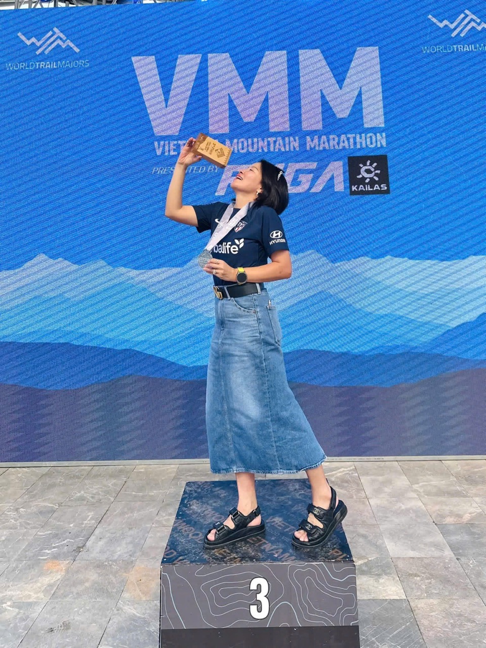 Đứng trên podium VMM Ultra 100 km — Hạng Ba nhóm nữ 50–59 tuổi, Sa Pa 2025. Cái bục này không bắt đầu từ tài năng, nó bắt đầu từ một ngày tôi dám ghi tên.